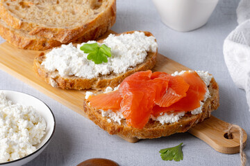 Sandwich with salted salmon and cream cheese on rustic background