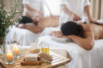 Products to please the senses. Shot of a mature couple enjoying a hot stone treatment.