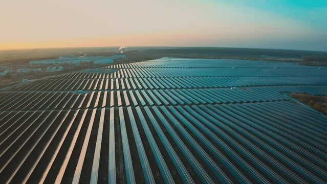Panoramic drone view of a field with solar panel systems.
