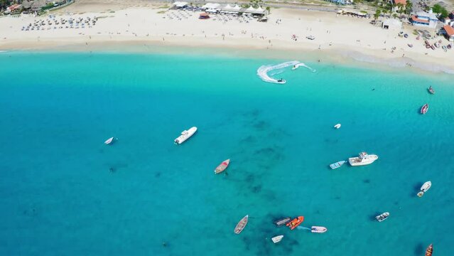 Jet Skis, boats and pier in Santa Maria, Sal Island, Cape Verde (Cabo Verde). Drone footage.