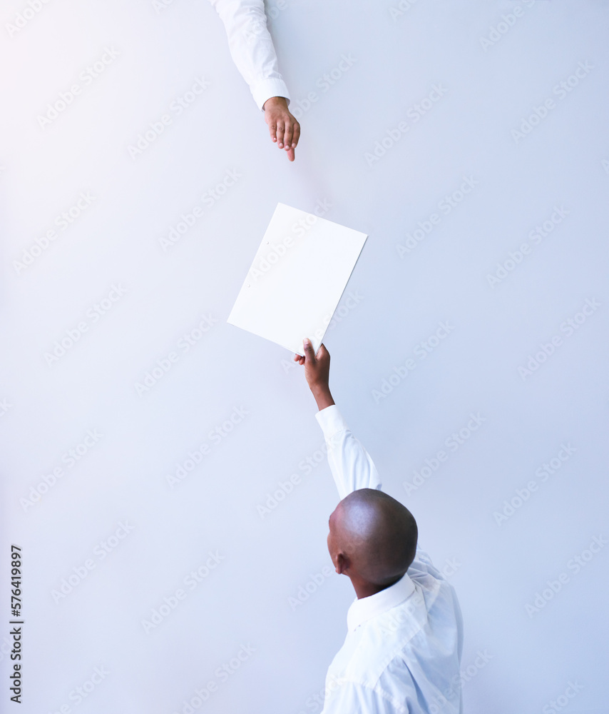 Poster i need you to sign this contract. rearview shot of a young businessman handing a document to a colle