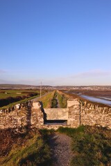 Fototapeta na wymiar Stone gate on country coastal path