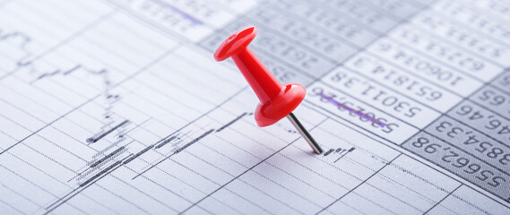 Marking financial chart by pins.Share listing and checking financial chart. Concept of banking, financial report and financial audit.