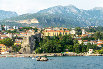 Fototapeta premium View of city Herceg Novi and fortress from sea. Coastal town in Montenegro located at entrance to Bay of Kotor and at foot of Mount Orjen. Adriatic Sea