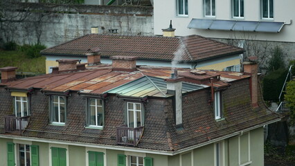 Traditional European building rooftop with Chimney smoke