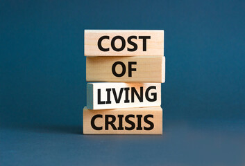 Cost of living crisis symbol. Concept words Cost of living crisis on wooden blocks. Beautiful grey table grey background. Business cost of living crisis concept. Copy space.