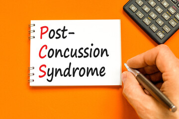 PCS post-concussion syndrome symbol. Concept words PCS post-concussion syndrome on white note on a beautiful orange background. Medical and PCS post-concussion syndrome concept. Copy space.