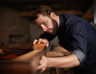 Since opportunity didnt knock, he decided to build a door. Shot of a young artisan working intently...