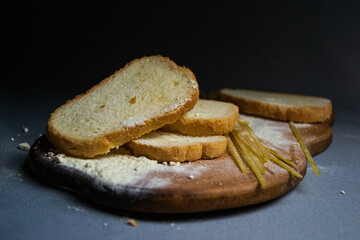 Bread, spaghetti and flour on gray background and wooden board