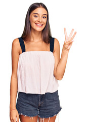 Young hispanic woman wearing casual clothes showing and pointing up with fingers number three while smiling confident and happy.