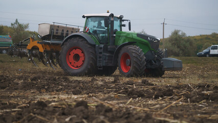 Tractor working in the field. Autumn tillage. Deep ripping with powerful tractor