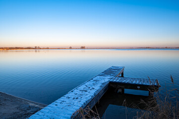 Wooden jetty at a lake in winter