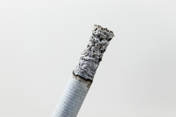 Lit tobacco cigarette being consumed