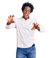 Handsome african american man with afro hair wearing casual clothes and glasses smiling funny doing...