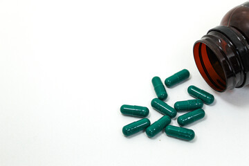 Medicine. Green pills inside the bottle