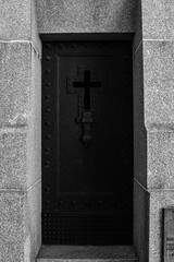 Iron door of a religious temple with a cross in the center