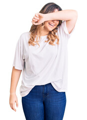 Fototapeta premium Young caucasian woman wearing casual clothes covering eyes with arm smiling cheerful and funny. blind concept.