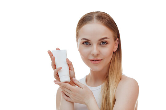 Portrait of a beautiful girl holding a bottle of shampoo conditioner in her hand.