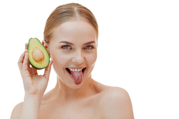 Pretty woman holds half an avocado in front of her face. Photo of attractive woman with perfect makeup on white background. Beauty & Skin care concept