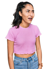 Fototapeta premium Hispanic teenager girl with dental braces wearing casual clothes angry and mad screaming frustrated and furious, shouting with anger. rage and aggressive concept.