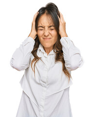 Young brunette woman wearing casual clothes suffering from headache desperate and stressed because pain and migraine. hands on head.