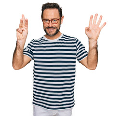 Middle age man wearing casual clothes and glasses showing and pointing up with fingers number eight while smiling confident and happy.