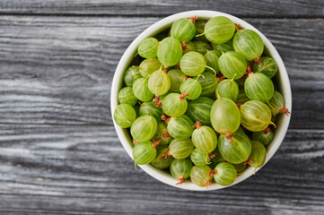 ripe agrus, gooseberries in a plate on the table
