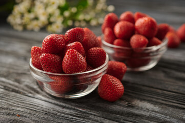 strawberries in two glass bowls on the table