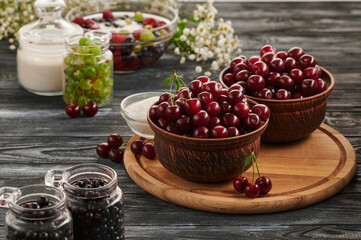 berries in bowls, ripe cherries in the plates