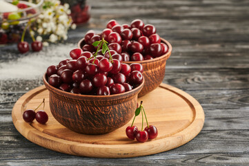 berries in bowls, ripe cherries in the plates