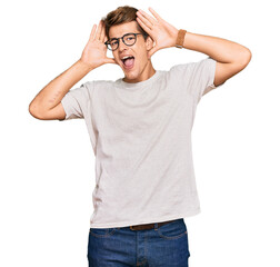 Handsome caucasian man wearing casual clothes and glasses smiling cheerful playing peek a boo with hands showing face. surprised and exited