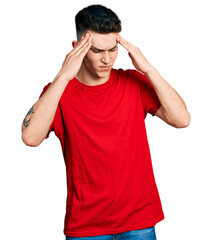 Young caucasian boy with ears dilation wearing casual red t shirt with hand on head, headache because stress. suffering migraine.