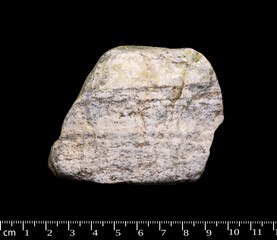 Gneiss metamorphic rock macro shot isolated on black background