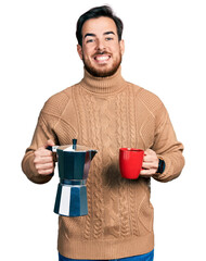 Young hispanic man drinking italian coffee celebrating crazy and amazed for success with open eyes screaming excited.