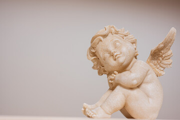 Baby angel with wings antique statue isolated.