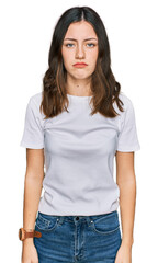 Young beautiful woman wearing casual white t shirt depressed and worry for distress, crying angry and afraid. sad expression.