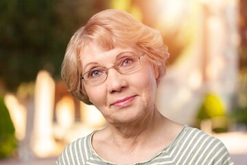 Beautiful senior old woman posing in park