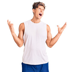 Young handsome man wearing sleveeless t shirt crazy and mad shouting and yelling with aggressive expression and arms raised. frustration concept.