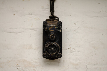 Vintage switch on the wall with a wire