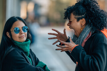 friends or girls in the street arguing angry