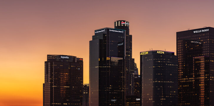 Los Angeles, United States - November 18, 2022: A picture of Downtown Los Angeles, with its skyscrapers topped by logos, at sunset.