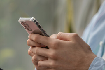 close-up of hands with mobile phone or smartphone