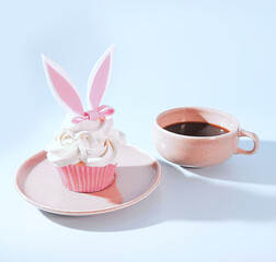 Coffee and Confections: A Pink Cup of Coffee with Festive Bunny Rabbit Cupcake with Icing