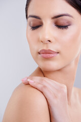 Beauty personified. Shot of a beautiful young woman posing against a gray background.