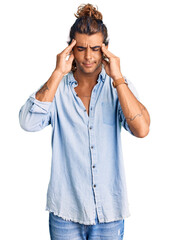 Young hispanic man wearing summer style with hand on head, headache because stress. suffering migraine.