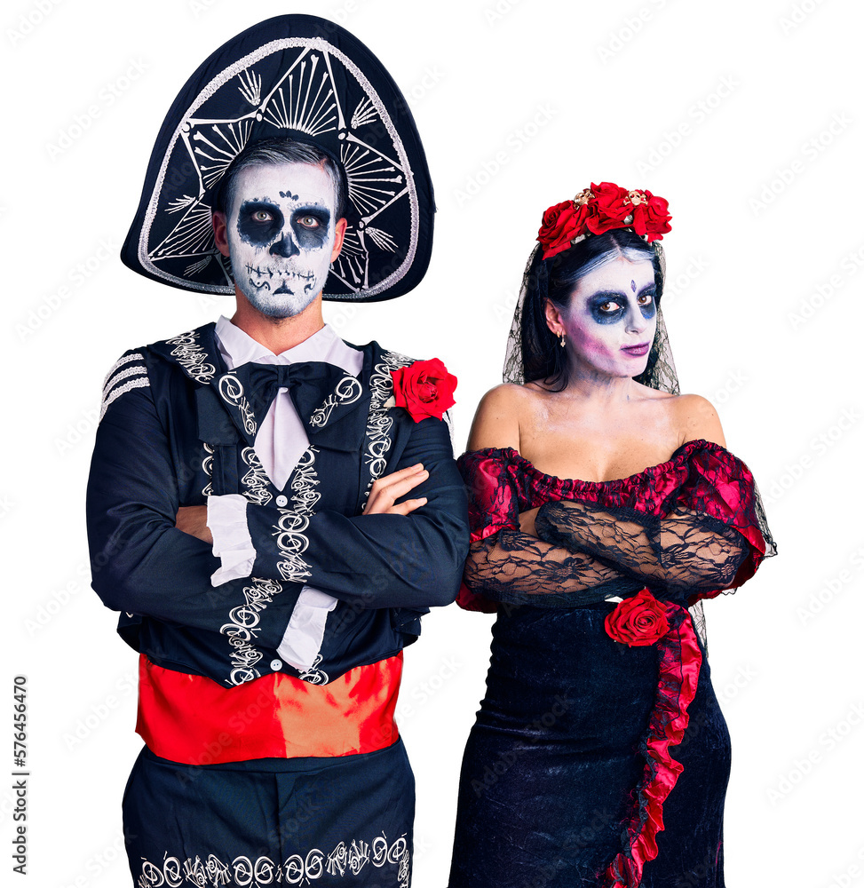 Wall mural Young couple wearing mexican day of the dead costume over background skeptic and nervous, disapproving expression on face with crossed arms. negative person.