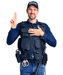 Young handsome man wearing police uniform smiling swearing with hand on chest and fingers up, making a loyalty promise oath