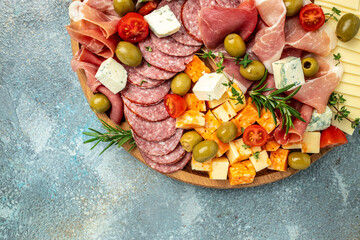 Appetizers table. Cheese, fuits and meat board on a blue background. banner, menu, recipe place for text, top view