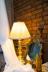 Vintage​ side bed​ lamp​ on​ the​  bedside table.​ Retro bed​ room interior​ design.