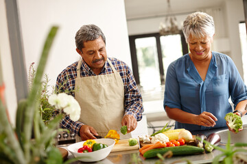 Homemade happiness. Shot of a happy senior couple cooking a healthy meal together at home.